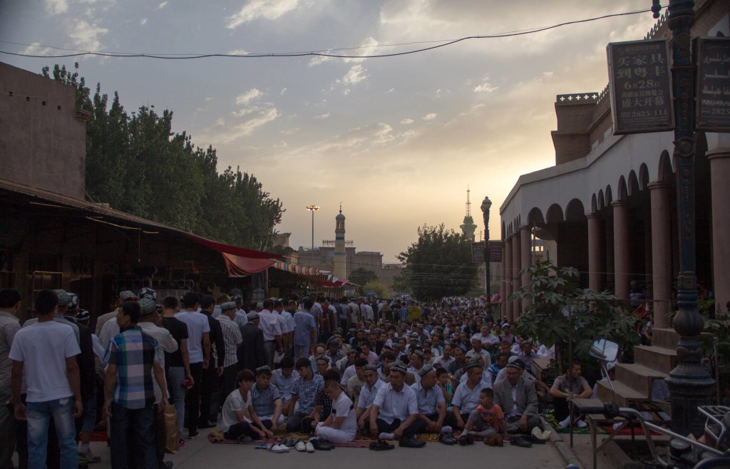 The sunrise at their backs, the men prepare themselves for worship, leaving a narrow passageway for other worshipers.